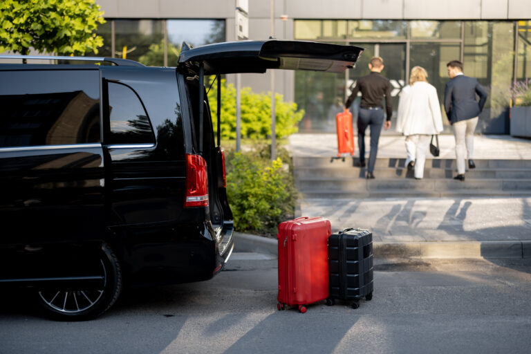 Luxury transfer service with luggage and clients arriving at a hotel or event location
